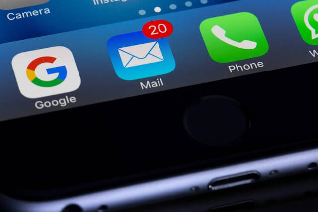 Smartphone screen showing unread emails notification on mail app icon.