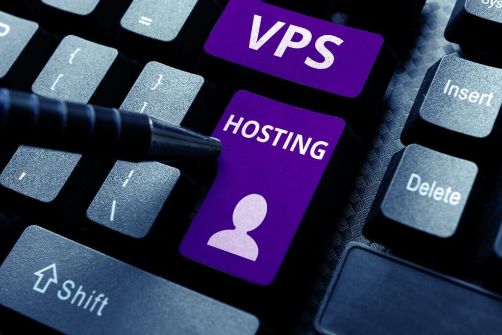 A computer keyboard with purple keys labeled "VPS" and "HOSTING" alongside a user icon; a pen points toward the keys, highlighting the option to buy a NVMe VPS.
